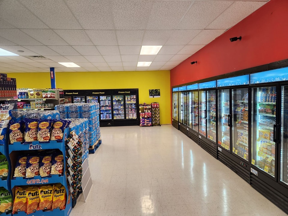 Interior grocery displays with frozen and perishable foods at an independent community grocery store